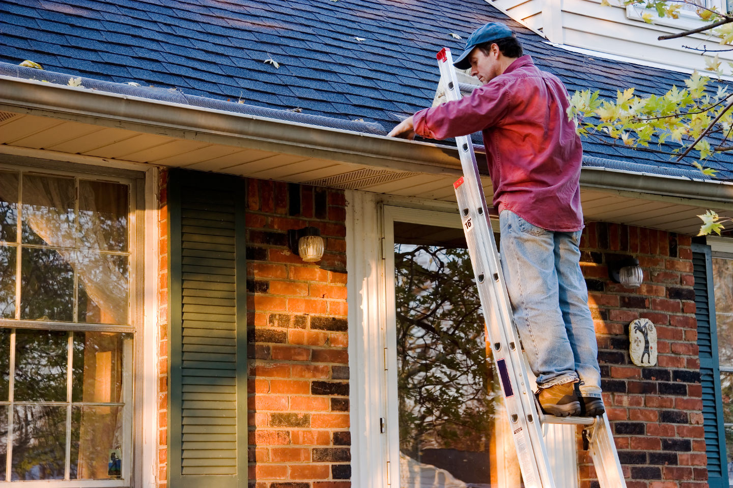 Dad cleaning out gutters